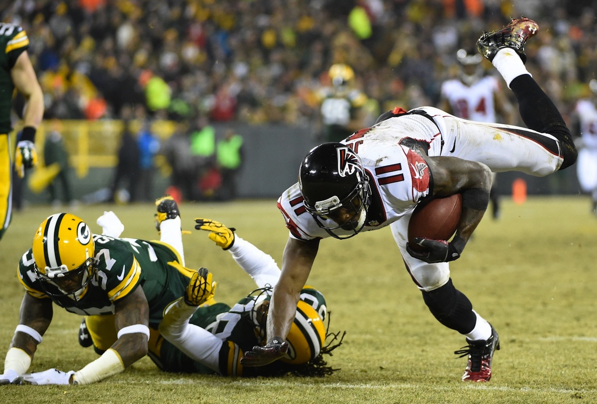 Sam Shields and Tramon Williams tackle Julio Jones after a reception by Benny Sieu—USA TODAY Sports.