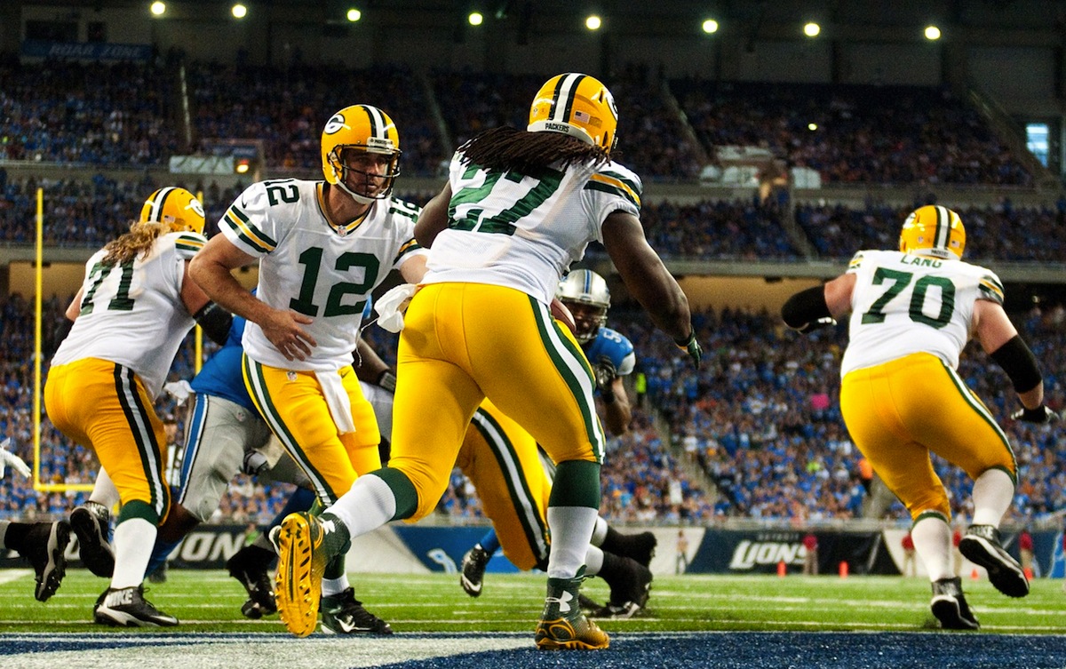 Aaron Rodgers hands off to Eddie Lacy in a 19-7 Packers loss to the Lions by Tim Fuller—USA TODAY Sports.