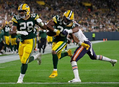 What Does Aaron Jones' Pay Cut Mean for AJ Dillon?