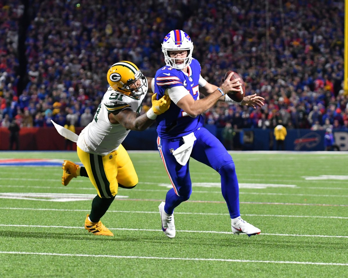 Buffalo Bills' Quarterback Josh Allen evades a tackler in the win over the Packers.