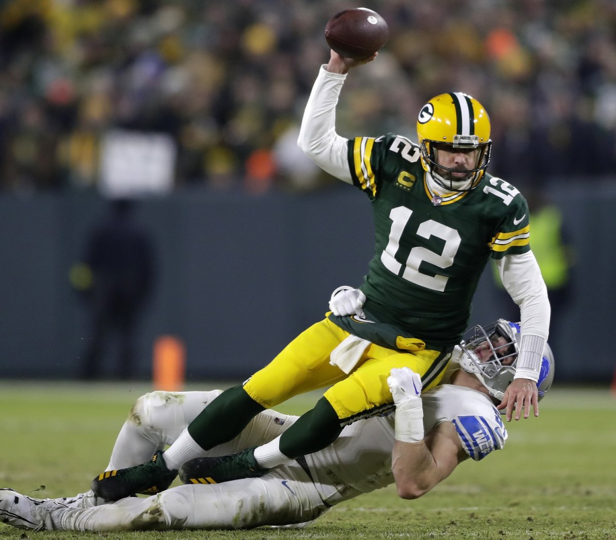 Packers QB Aaron Rodgers is hauled down by Lions end Aidan Hutchinson in Detroit's 20-16 win.
